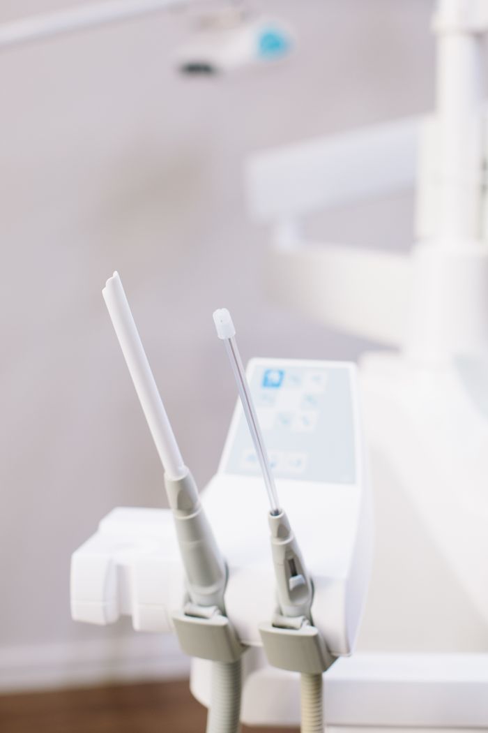 services-01 Close-up view of dental tools in a modern clinic setting.